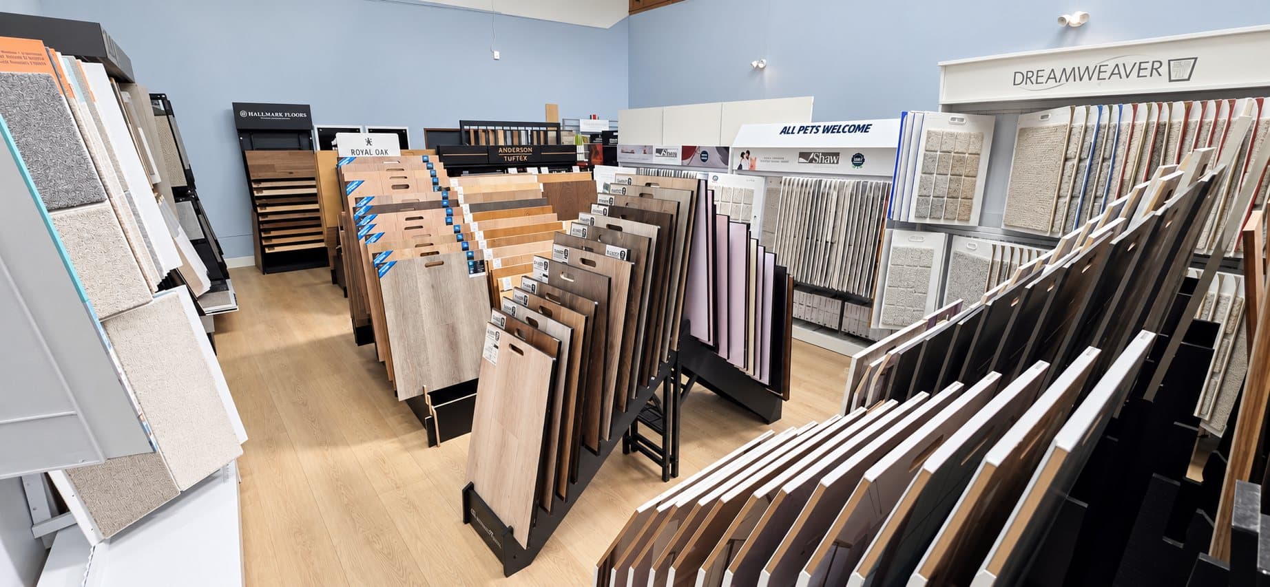 Luxury vinyl plank and carpet sample displays in the V & A Flooring Inc showroom