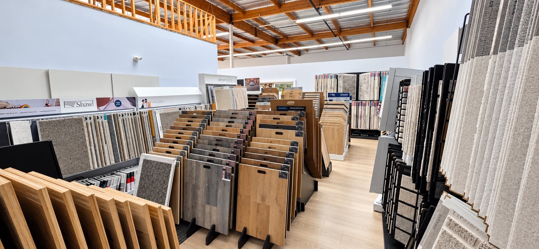 Carpet and vinyl plank sample racks in the V & A Flooring Inc showroom