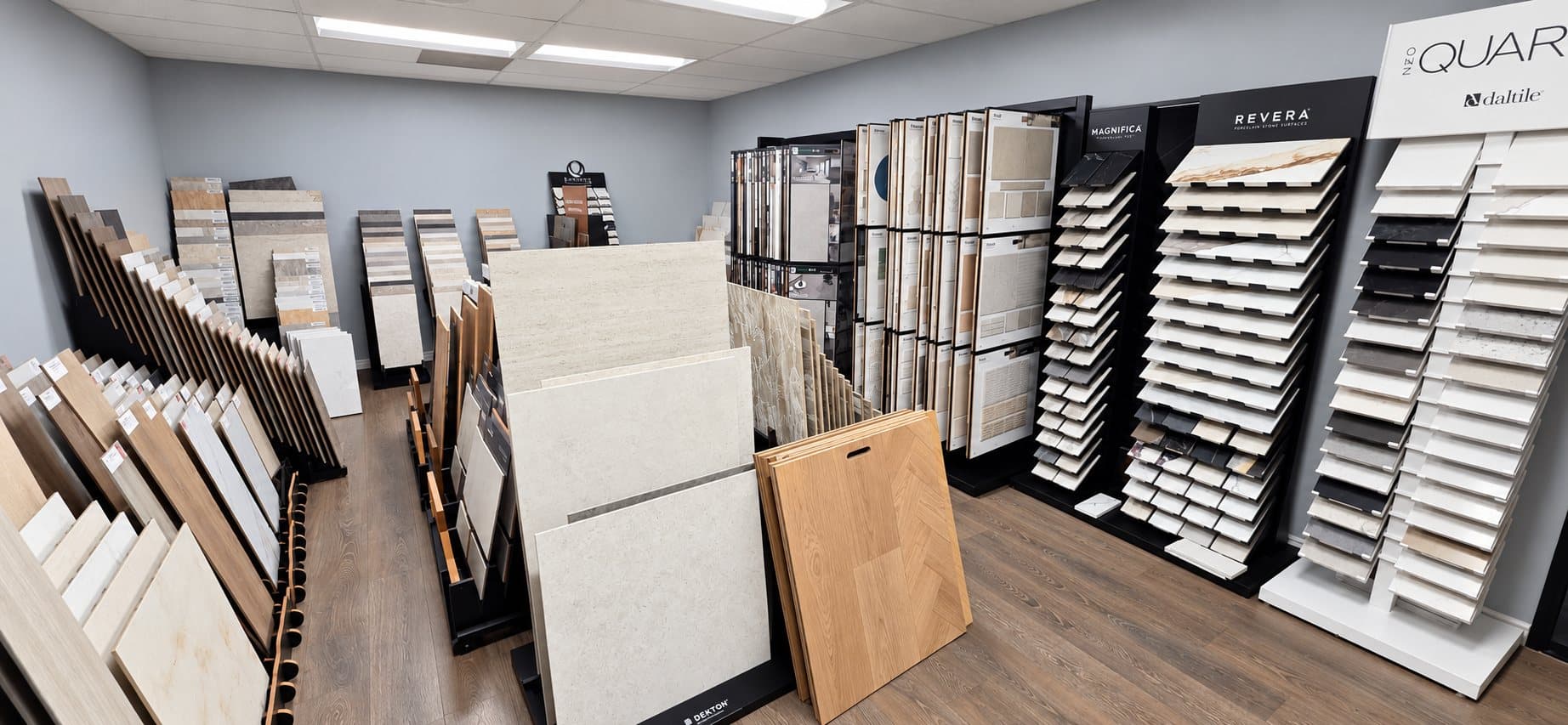 Porcelain tile and stone-look sample displays in the V & A Flooring Inc showroom